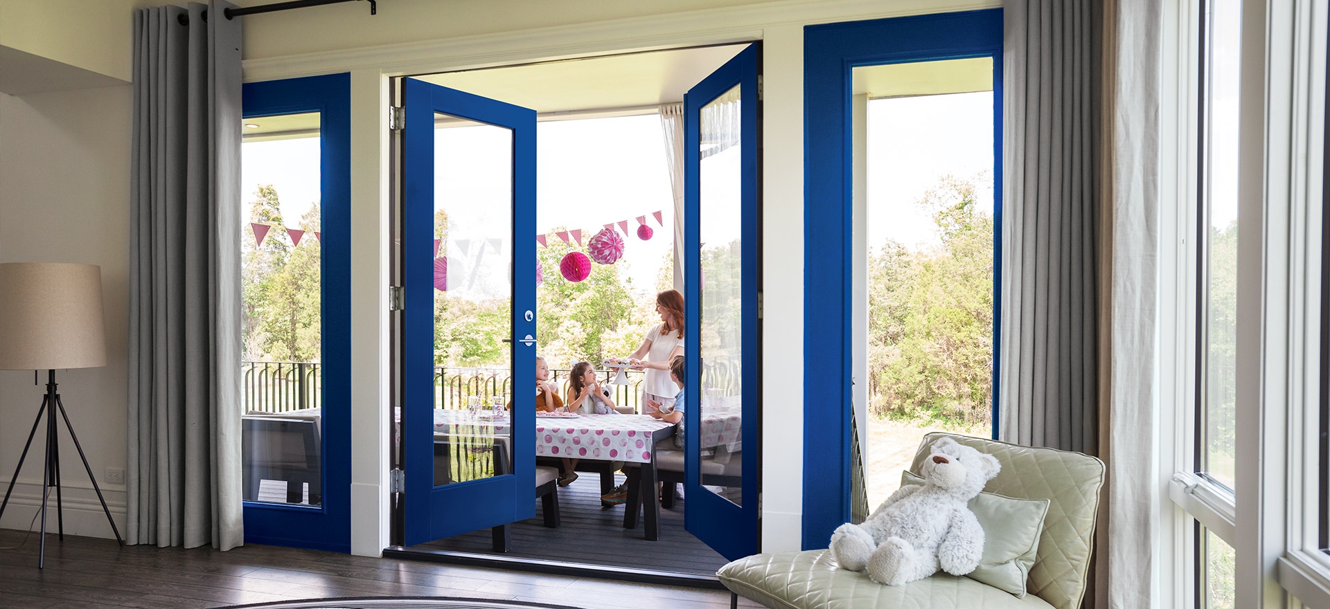 Full lite exterior blue VistaGrande double doors open view of a little girl's party with pink décor