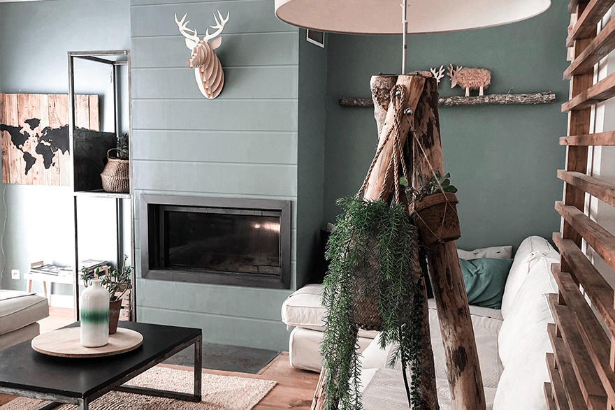 Modern Farmhouse style living room with a blue walls and horizontal shiplap fireplace, white sofa, and rustic style décor