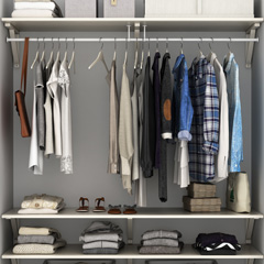 Organized closet with hanging clothes and lots of storage space
