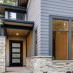 Modern style home front porch with a black 4 equal lite exterior door