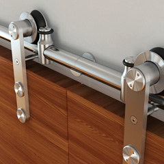 Close up of a stainless steel track and hardware holding up double doors
