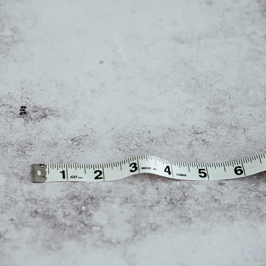 Close-up of a white measuring tape that is stretched out to 6.5 inches