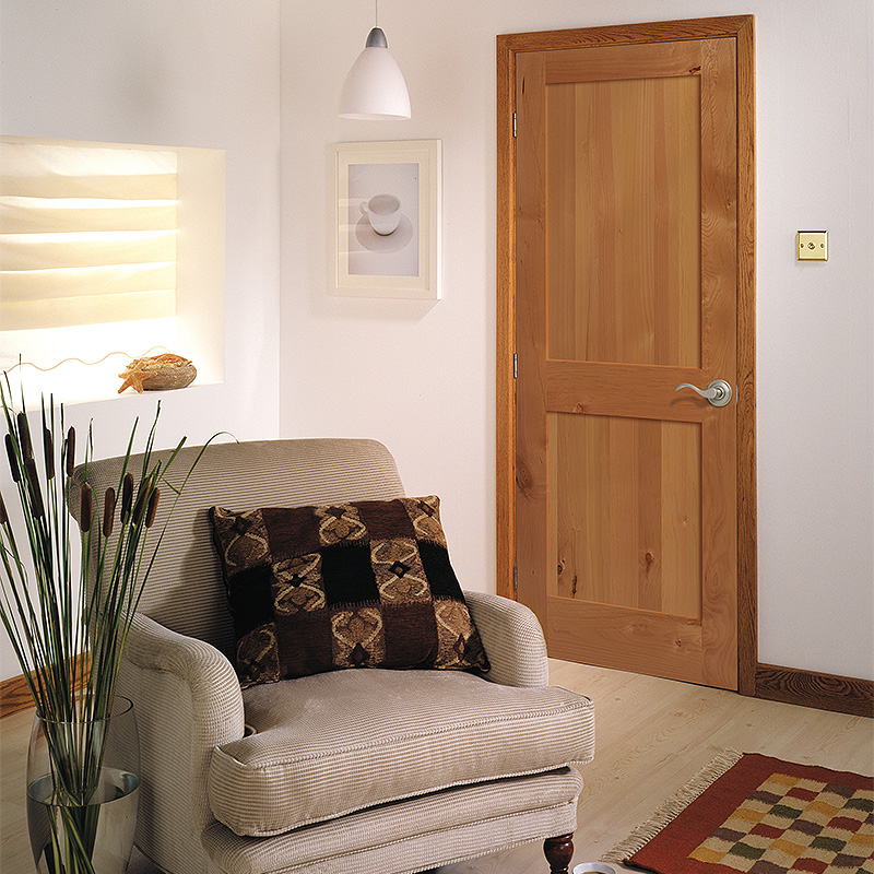 Interior square top 2 panel Knotty Alder door in a traditional style living area