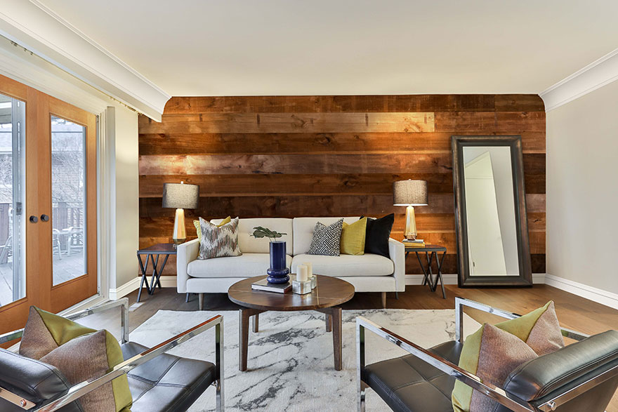 Modern Cottage style living room with a Pakari accent wall and full lite double doors leading to a snow covered backyard