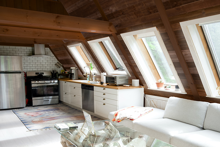  Triangle shaped roof cabin interior with kitchen and sitting area