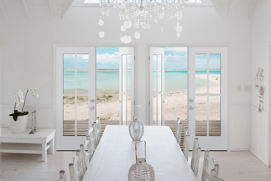 All white Coastal style dining room with a beach view using 2 Vistagrande double doors with SDL bars 
