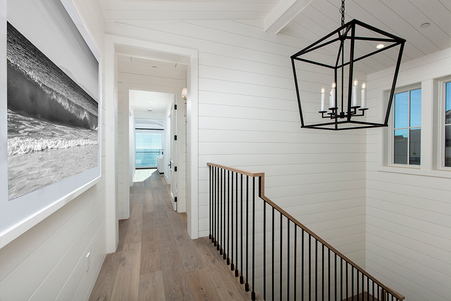 Upstairs hallway view of horizontal white shiplap walls